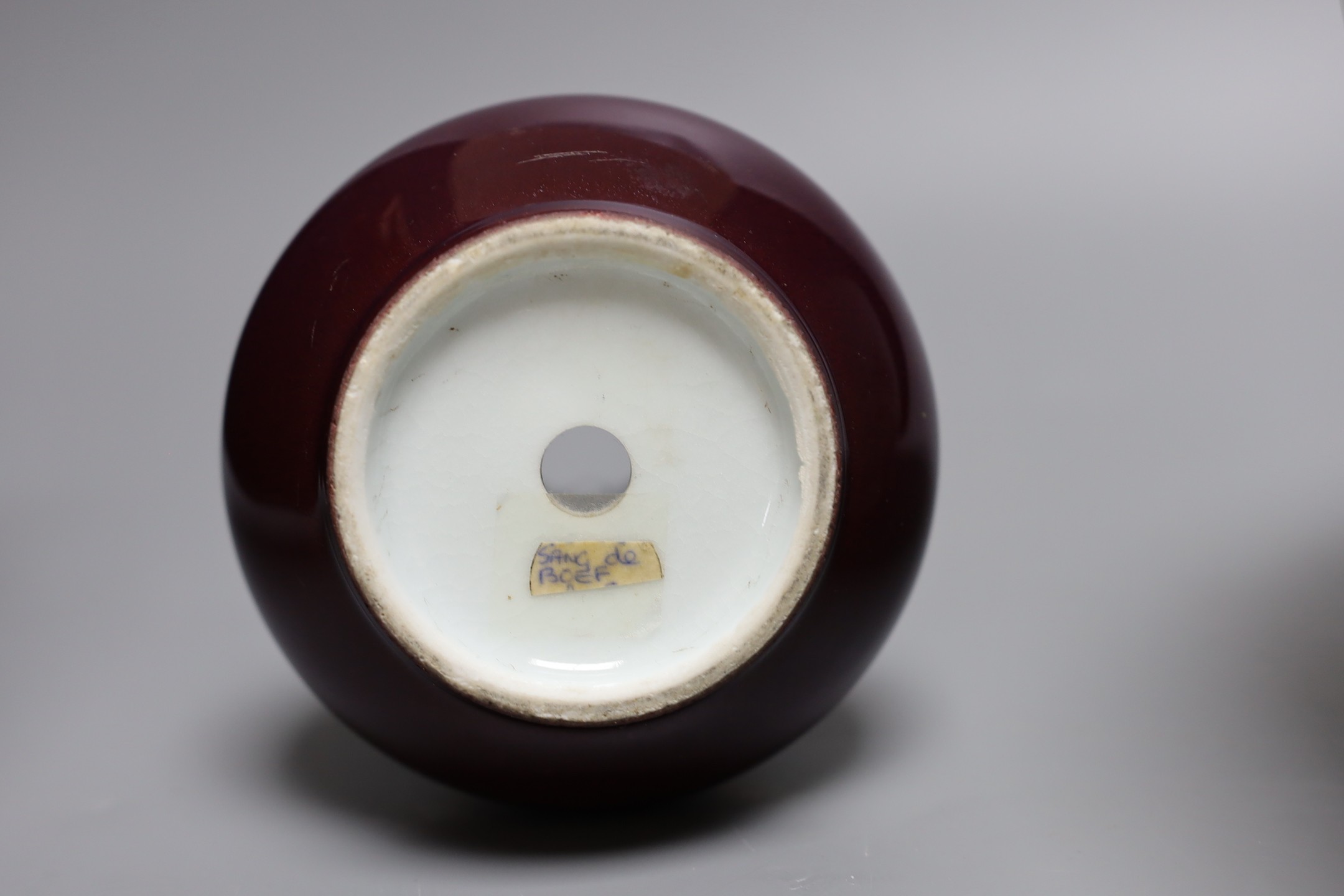 An 18th century Japanese Imari dish (af), another Imari dish, an 18th century Chinese export bowl (af) and a Chinese sang de boeuf vase, diameter of largest bowl 29cm